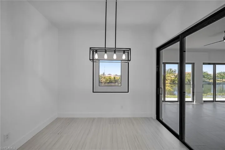 Unfurnished dining area featuring a water view and baseboards