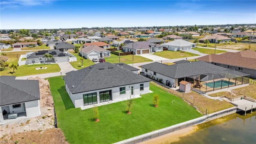 Drone / aerial view with a water view and a residential view