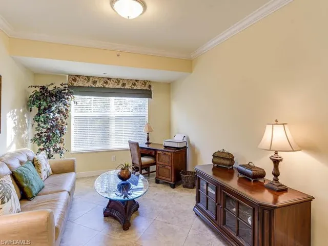Office space featuring light tile patterned flooring and crown molding