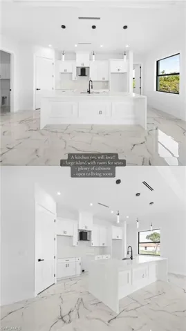 White kitchen cabinetry, large central island with seating capacity, dark-finish pendant lighting, dark-finish faucet, and marble-finish flooring