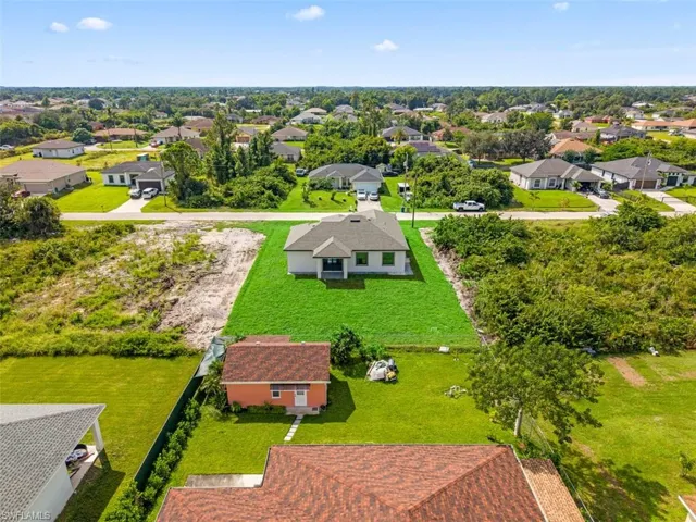 Well-maintained lawn surrounding a single-story residence with a gabled roof