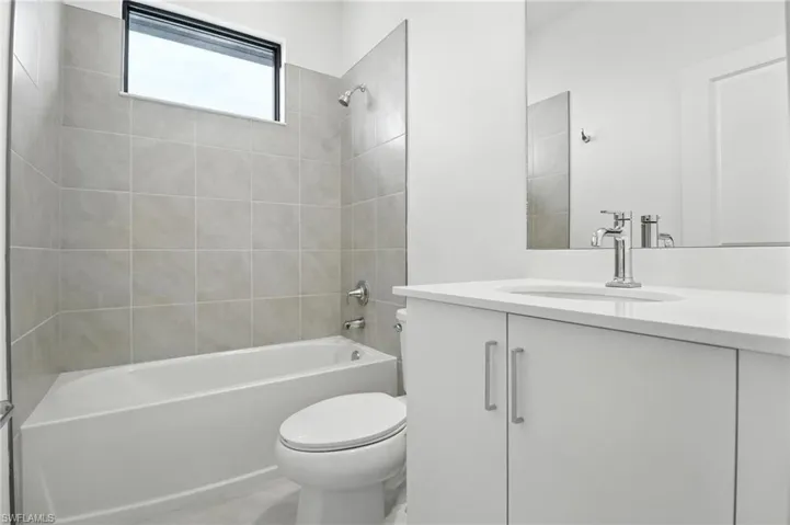 Bathroom featuring vanity and bathing tub / shower combination