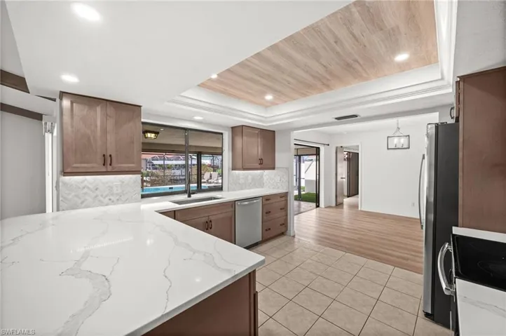 Kitchen with View of Family Room Leading Out to Pool Area
