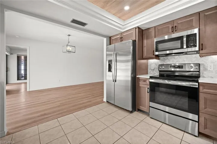 Remolded Kitchen - Wood Cabinets, Quartz Countertops & Stainless Steel Appliances