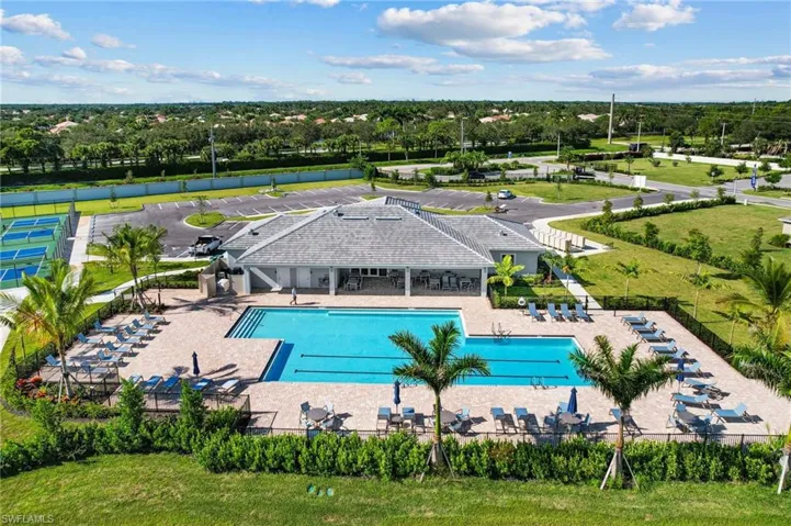 View of community pool with a lounging area