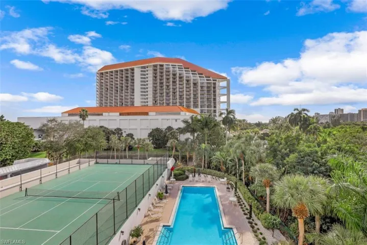 View of pool featuring tennis court