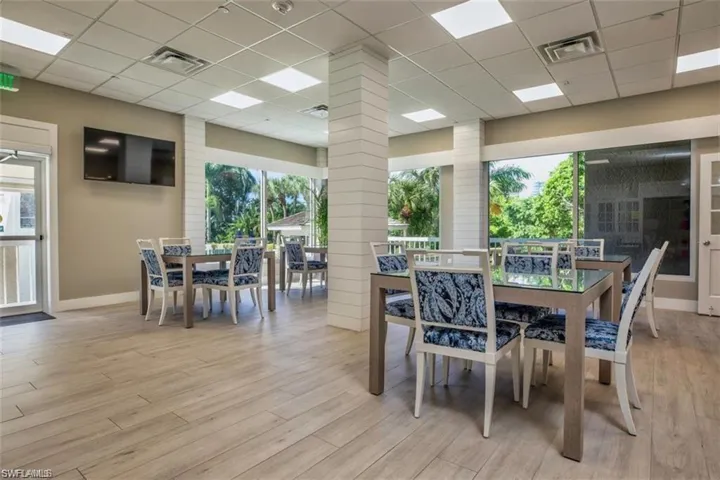 Dining area with light wood-type flooring and a drop ceiling