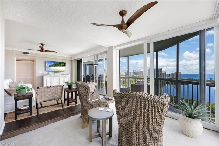 Sunroom with a water view and ceiling fan