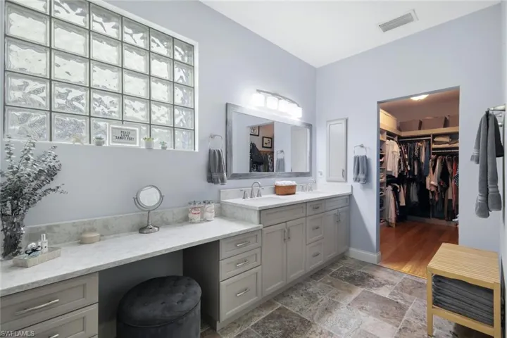 En suite primary bath features a HUGE walk-in closet.