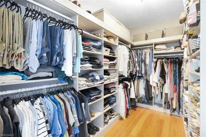 HUGE primary suite closet with custom closet system.  Notice the bamboo flooring.