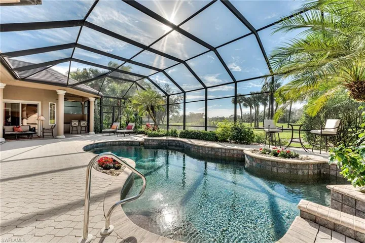 View of pool featuring an outdoor hangout area, a lanai, a bar, ceiling fan, and a patio area