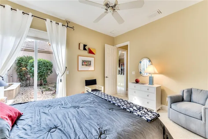 Bedroom featuring access to outside, light colored carpet, and ceiling fan