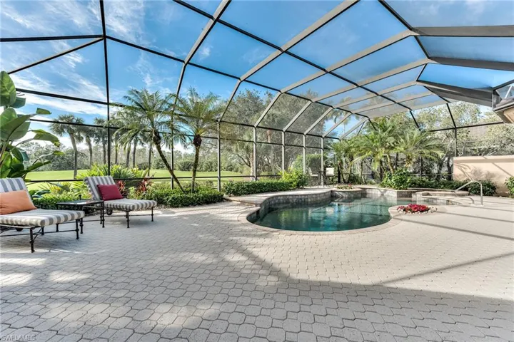 View of swimming pool with a patio and glass enclosure