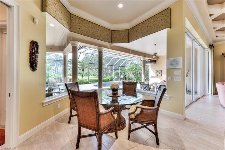 Dining area featuring ceiling fan, plenty of natural light, and ornamental molding