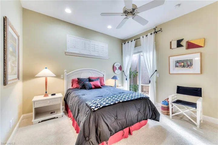 Bedroom featuring ceiling fan and light carpet