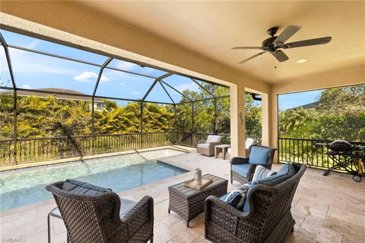 View of swimming pool with an outdoor living space, a patio, a lanai, and ceiling fan