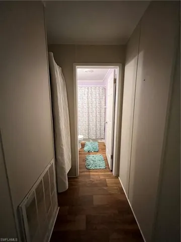Hallway featuring dark wood-type flooring