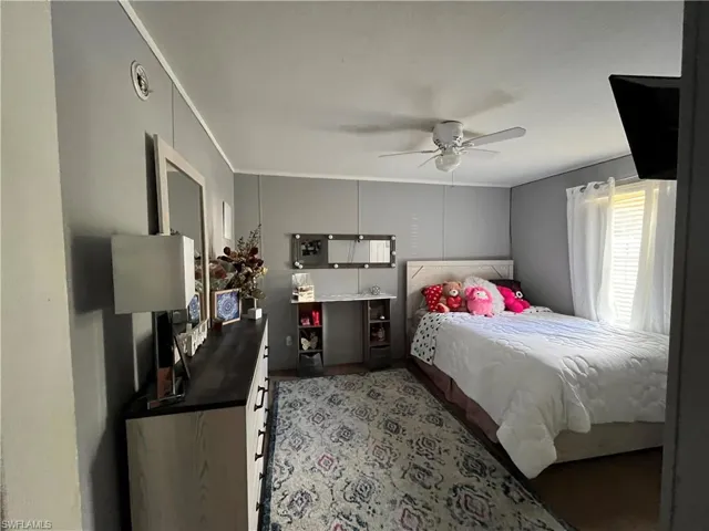 #1Bedroom with ceiling fan and ornamental molding