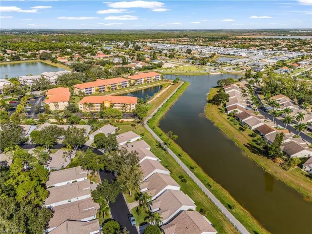 Aerial overview of property's location with nearby suburban area and a nearby lake with walking trails