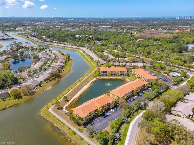 Aerial view of property's location with a large body of water and nearby suburban area
