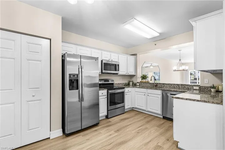 White cabinets, stainless appliances,granite counters