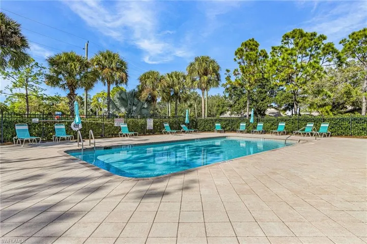 Community pool with a patio