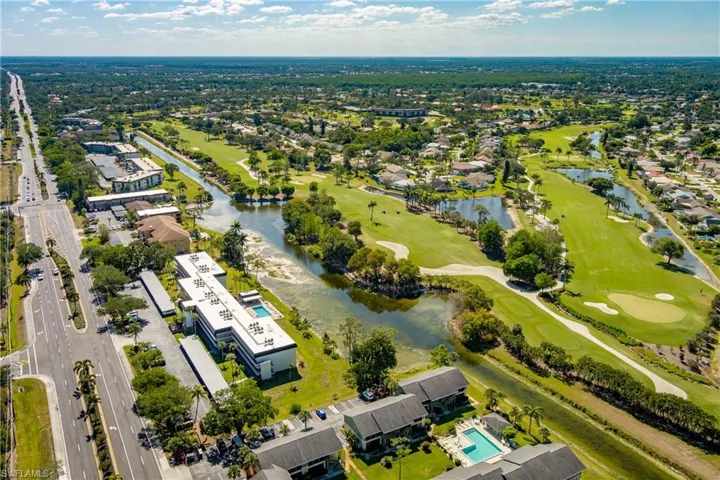 Birds eye view of property featuring view of golf course and a water view