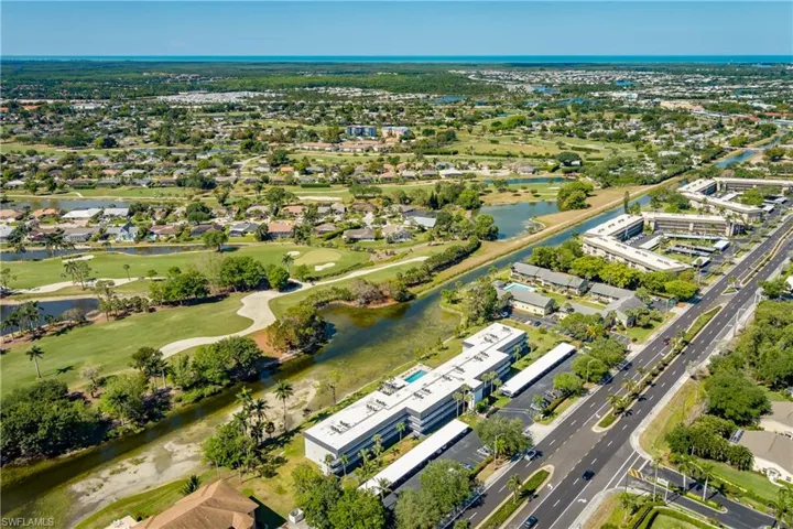 Bird's eye view with view of golf course and a water view