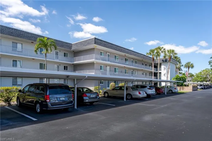 View of property featuring covered parking