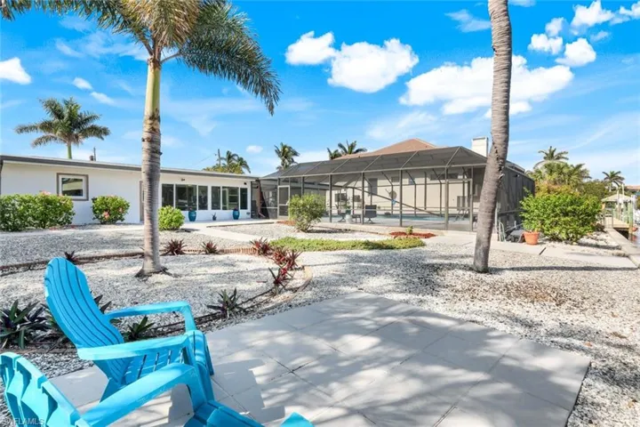 Rear view of house featuring a lanai, a swimming pool, and a patio area