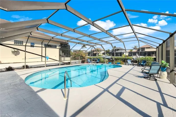 View of swimming pool with a lanai and a patio