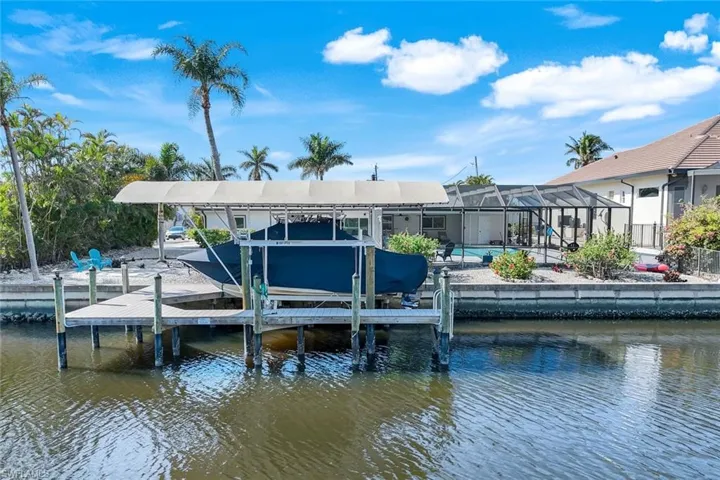 View of dock with a water view and glass enclosure