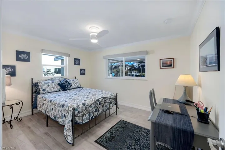 Bedroom featuring crown molding, ceiling fan, and light hardwood / wood-style flooring