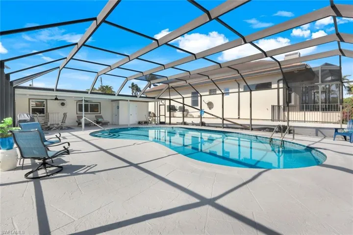 View of swimming pool with a lanai, a patio area, and ceiling fan