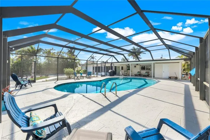 View of pool with a patio and a lanai