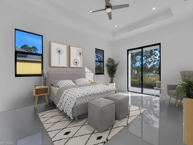 Bedroom featuring access to outside, a tray ceiling, and ceiling fan. Furnitures are not included