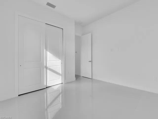 bedroom # 4 with tile patterned flooring and a closet
