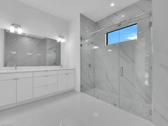 Bathroom with vanity and a shower with door