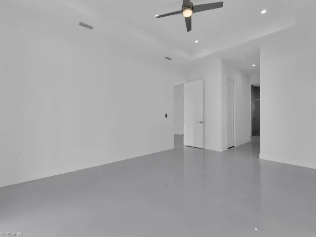 with ceiling fan and concrete flooring