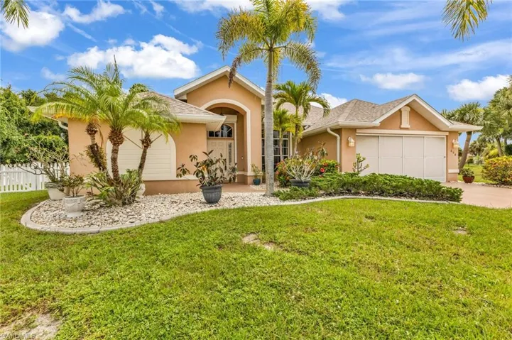 Stucco exterior with a hip roof and an attached two-car garage