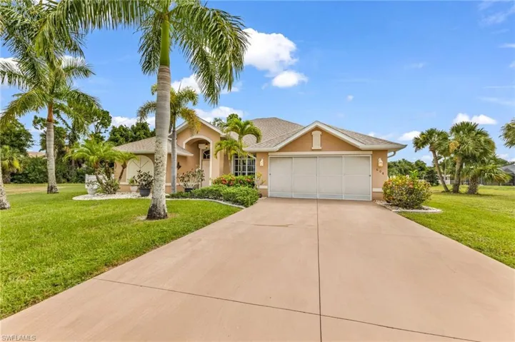 Stucco exterior with an attached two-car garage, concrete driveway, and a shingle roof