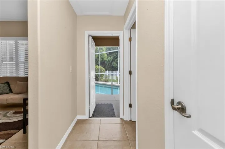 Tiled hallway with neutral wall paint and white trim