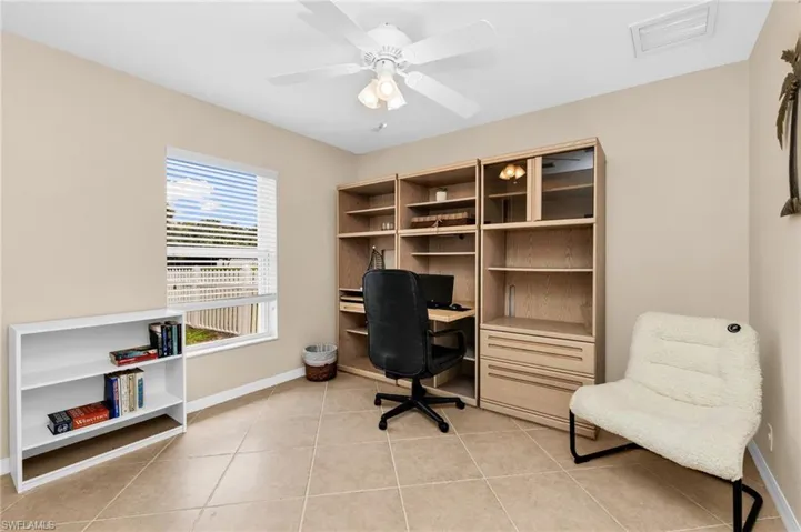 Interior room with light tan wall paint and rectangular tile flooring