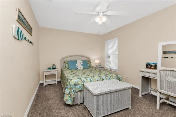 Carpeted room with a ceiling fan, a window with blinds, and neutral-toned walls