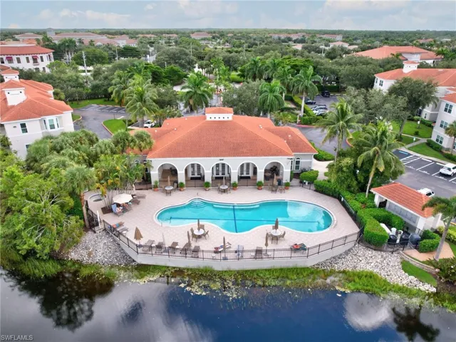 Community pool featuring a patio and a water view