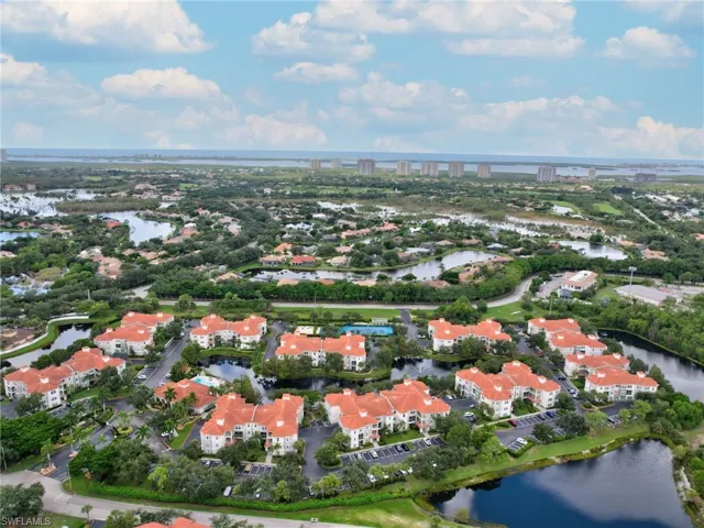 Aerial view of property and surrounding area featuring a large body of water