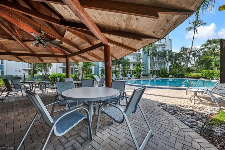 View of patio / terrace featuring a ceiling fan, a community pool, and outdoor dining space