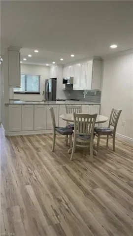 Dining space featuring light hardwood / wood-style floors and sink
