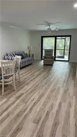 Living room featuring ceiling fan and light hardwood / wood-style floors