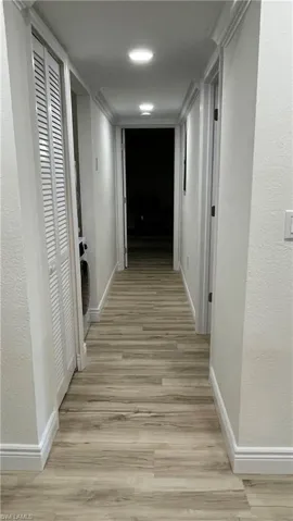 Hall featuring light wood-type flooring